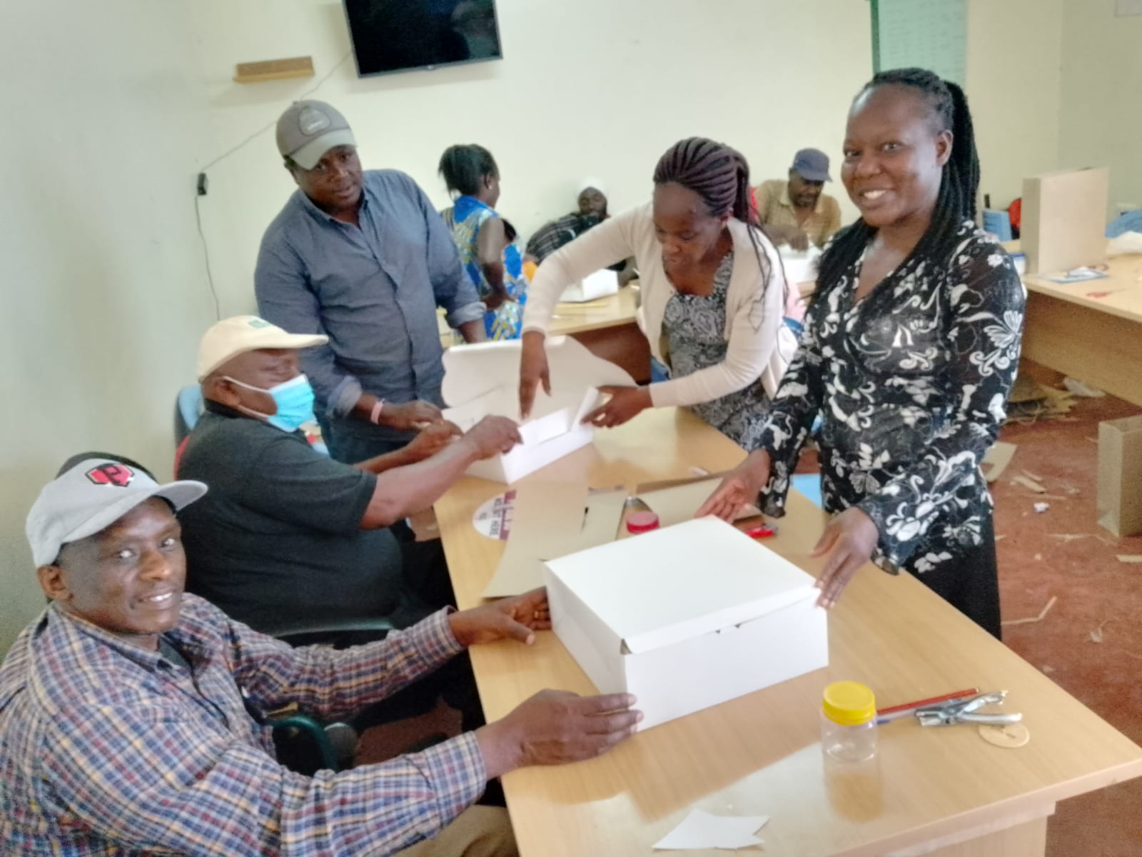 UDPL members packaging finished khaki bags into boxes